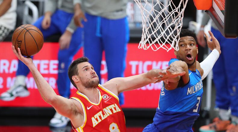 Hawks forward Danilo Gallinari goes to the basket against Milwaukee Bucks forward Giannis Antetokounmpo during the second quarter of Game 3 of the Eastern Conference finals Sunday, June 27, 2021, in Atlanta. (Curtis Compton / Curtis.Compton@ajc.com)