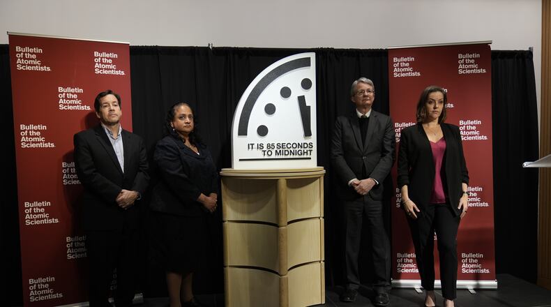 The Bulletin of the Atomic Scientist members, from left, Jon B. Wolfsthal, Asha M. George, Steve Fetter and Alexandra Bell, reveal the Doomsday Clock, set to 85 seconds to midnight, during a news conference at the Carnegie Endowment for International Peace, Friday, Jan. 23, 2026, in Washington. (AP Photo/Pablo Martinez Monsivais)