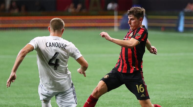 July 21, 2019 Atlanta: Atlanta United midfielder Emerson Hyndman works the ball between the legs of D.C. United midfielder Russell Canouse in a soccer match on Sunday, July 21, 2019, in Atlanta. Curtis Compton/ccompton@ajc.com