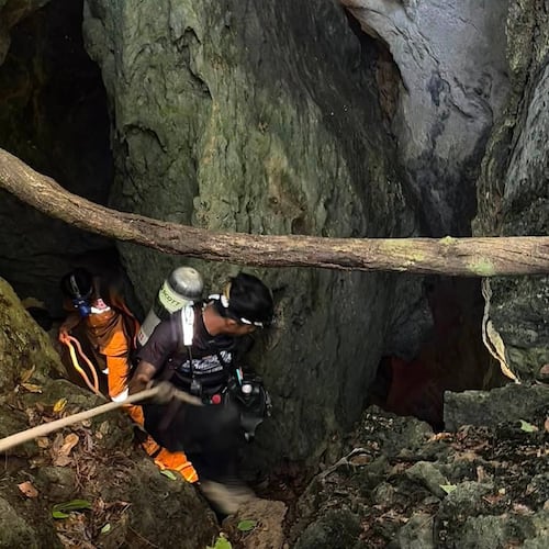 In this image released by Metta Tham Rescue Kalasin, rescuers try to reach people who have been trapped in a cave in Xaisomboun province, Laos, Tuesday, May 26, 2026. (Metta Tham Rescue Kalasin via AP)