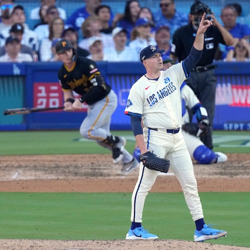 Los Angeles Dodgers starting pitcher Tarik Skubal, right, gestures as Pittsburgh Pirates' Henry Davis flies out during the seventh inning of a baseball game Saturday, Aug. 22, 2026, in Los Angeles. (AP Photo/Mark J. Terrill)