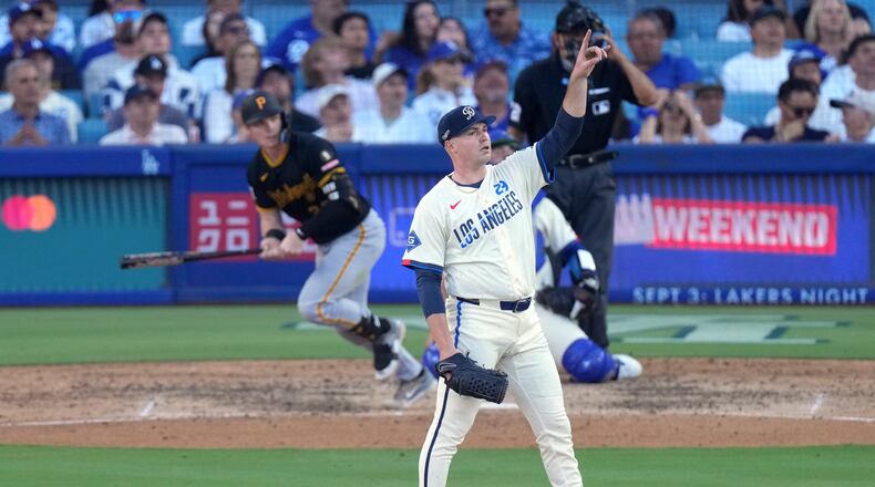 Los Angeles Dodgers starting pitcher Tarik Skubal, right, gestures as Pittsburgh Pirates' Henry Davis flies out during the seventh inning of a baseball game Saturday, Aug. 22, 2026, in Los Angeles. (AP Photo/Mark J. Terrill)