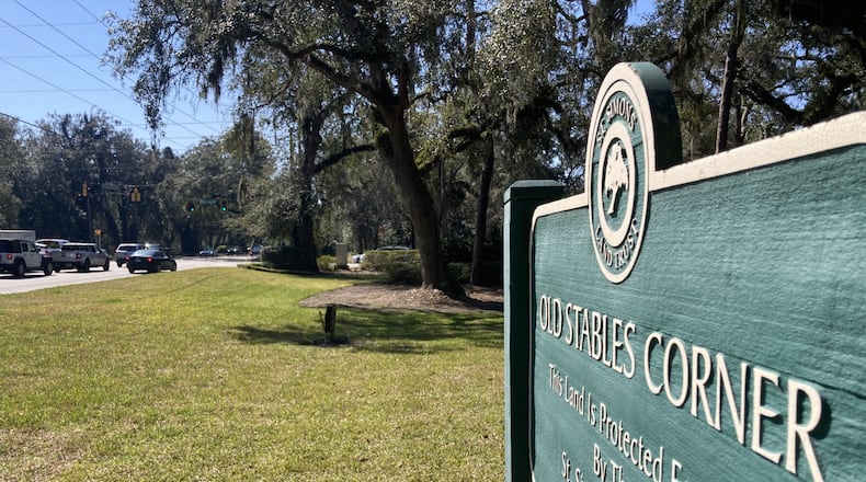 Traffic passes through the intersection of Sea Island and Frederica roads on St. Simons Island. A planned traffic circle would encroach on Old Stables Corner, home to 17 century-old live oak trees. (Adam Van Brimmer/AJC)