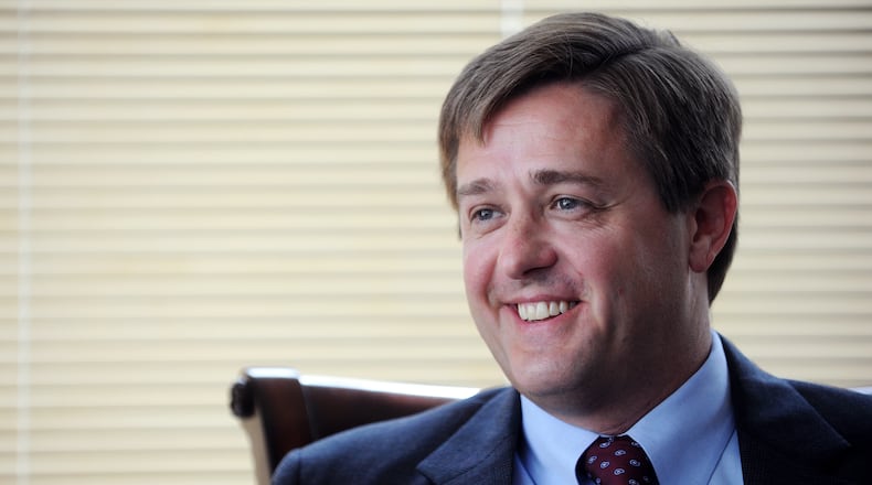 Georgia Labor Commissioner Mark Butler speaks with a visitor in his downtown Atlanta office.
