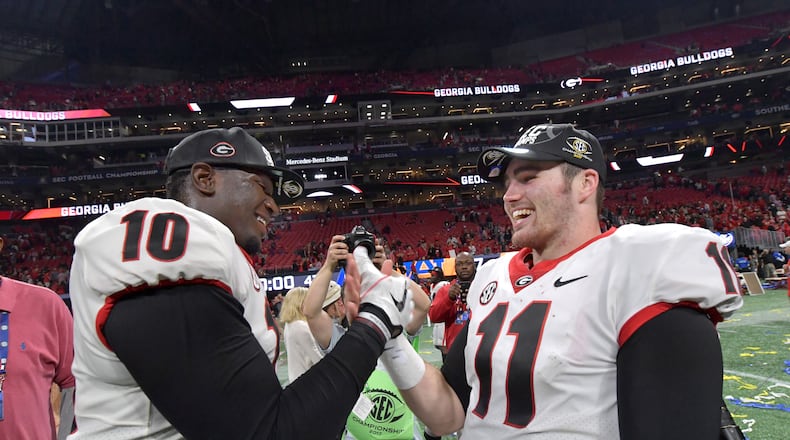 December 2, 2017 Atlanta: Georgia defensive lineman Malik Herring (10) and Georgia quarterback Jake Fromm (11) celebrate after their victory over the Auburn during the Southeastern Conference championship NCAA college football game at Mercedes-Benz Stadium, December 2, 2017, in Atlanta.  Hyosub Shin / hshin@ajc.com