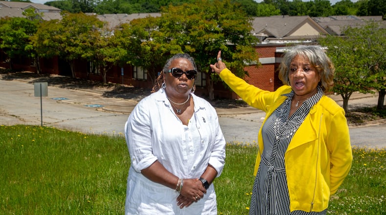 Theresa Bailey (L) and Joyce Moore stand in front of the old Hooper-Renwick School on May 11 and talk about why preserving the memory of the Lawrenceville school is essential. Bailey and Moore, both former students of the school, serve as chair and vice chair of a committee dedicated to preserving the Hooper-Renwick building. STEVE SCHAEFER FOR THE ATLANTA JOURNAL-CONSTITUTION