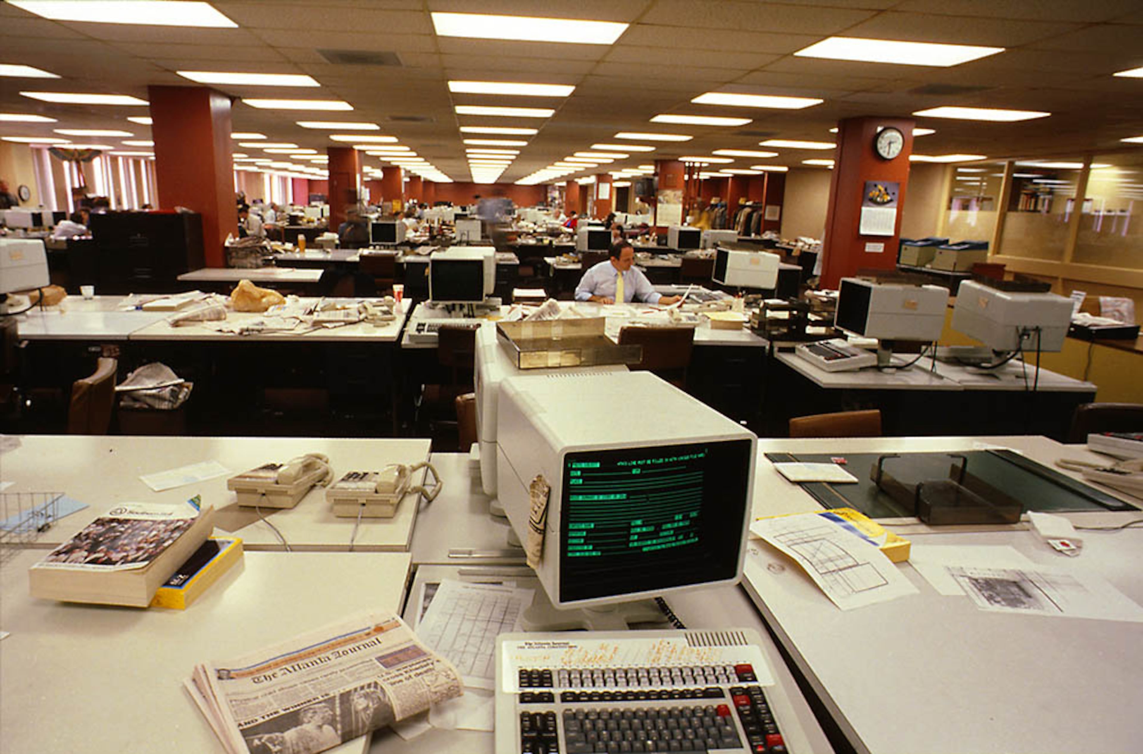 An ATEX system computer sits in the foreground of the AJC newsroom in 1985, the same year the paper opened another printing press in Gwinnett. (AJC File)