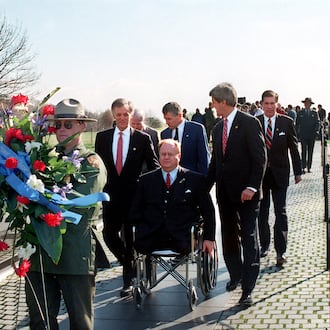 In this photo from 1997, then-U.S. Sen. Max Cleland, D-Ga. (in wheelchair), and fellow senators (left to right) Bob Kerrey, D-Neb.; John McCain, R-Ariz.; Charles Hagel, R-Neb.; John Kerry, D-Mass.; and Chuck Robb, D-Va. walk along the Vietnam Veterans Memorial wall behind the wreath they would lay to commemorate the 15th anniversary of groundbreaking for the memorial. All six senators served in Vietnam, and Cleland lost both legs and an arm in that war. (Rick McKay/Washington Bureau)