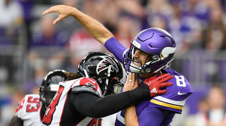 MINNEAPOLIS, MINNESOTA - SEPTEMBER 08: Takkarist McKinley #98 of the Atlanta Falcons hits quarterback Kirk Cousins #8 of the Minnesota Vikings during the second quarter of the game at U.S. Bank Stadium on September 8, 2019 in Minneapolis, Minnesota. (Photo by Hannah Foslien/Getty Images)