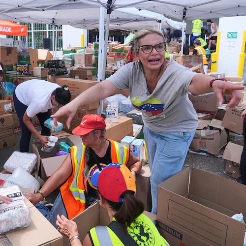 Lisa Galindez calls on other volunteers to help pack baby items at the Global Empowerment Mission Venezuela relief donation site Tuesday, June 30, 2026, in Doral, Fla. (AP Photo/Marta Lavandier)