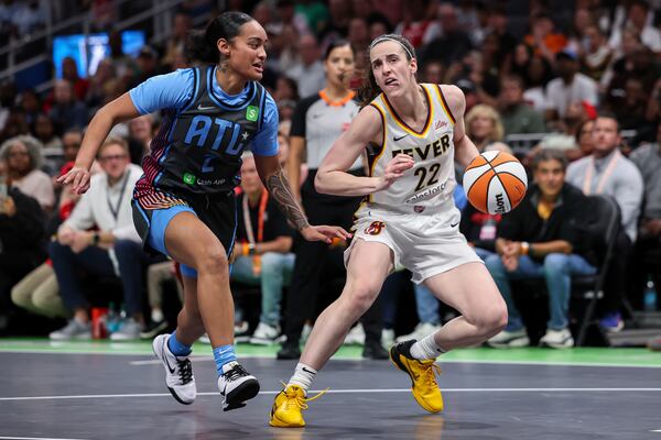 Indiana Fever guard Caitlin Clark (22) creates space against Atlanta Dream guard Te-Hina Paopao (2) in the first half of an WNBA basketball game, Thursday, May, 22, 2025, in Atlanta. (AP Photo/Colin Hubbard)