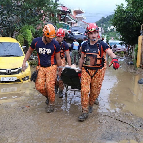 Rescue workers carry an injured resident as Typhoon Kalmaegi affects Cebu city, central Philippines on Tuesday, Nov. 4, 2025. (AP Photo/Jacqueline Hernandez)