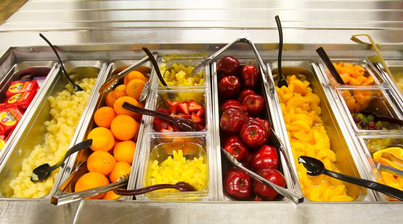 The fruit bar in the cafeteria at Talawanda High School, Thursday, Apr. 3, 2014. GREG LYNCH / STAFF When students were served healthier lunches, their test scores increased. according to a major study. (AJC File)