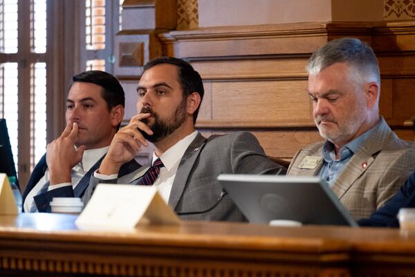 State Rep. Martin Momtahan (center) has been in the state Legislature since 2019. (Ben Gray for the AJC).