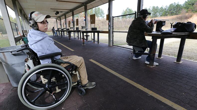 Department of Natural Resources range safety officer Chip Madren, 20, works Tuesday at the Clybel Shooting Range at the Charlie Elliott Wildlife Center in Mansfield. Seven years ago Madren was given two years to live after being diagnosed with brain cancer. He began working with the DNR earlier this year to help make public hunting areas accessible to those with disabilities. Curtis Compton/ccompton@ajc.com