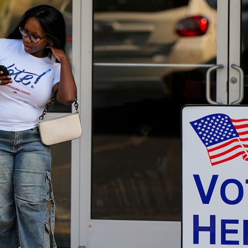 A woman leaves a voting center after voting, Tuesday, May 19, 2026, in Marietta, Ga. (AP Photo/Mike Stewart)