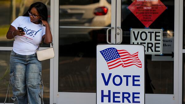 A woman leaves a voting center after casting her ballot in last month's primaries in Marietta. (Mike Stewart/AP)