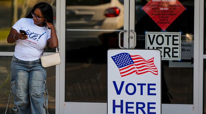 A woman leaves a voting center after voting, Tuesday, May 19, 2026, in Marietta, Ga. (AP Photo/Mike Stewart)