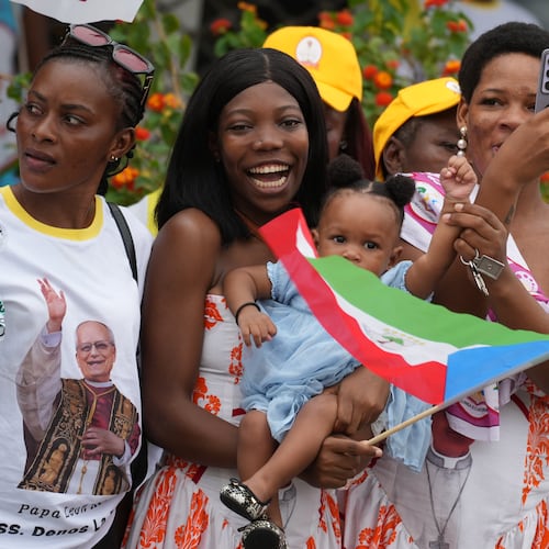 People wait for Pope Leo XIV in Malabo, Equatorial Guinea, Tuesday, April 21, 2026, on the ninth day of his 11-day pastoral visit to Africa. (AP Photo/Andrew Medichini)