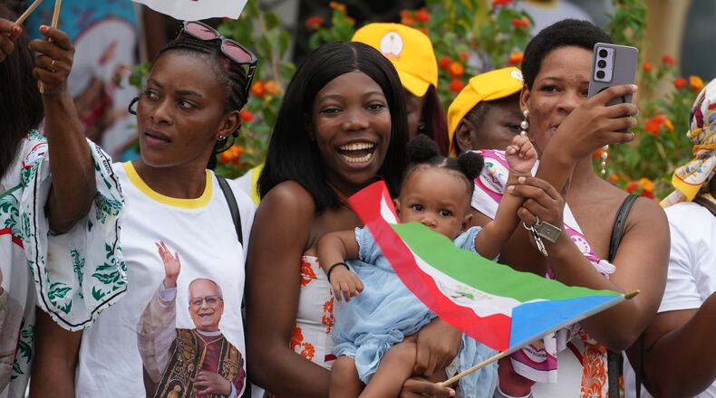 People wait for Pope Leo XIV in Malabo, Equatorial Guinea, Tuesday, April 21, 2026, on the ninth day of his 11-day pastoral visit to Africa. (AP Photo/Andrew Medichini)