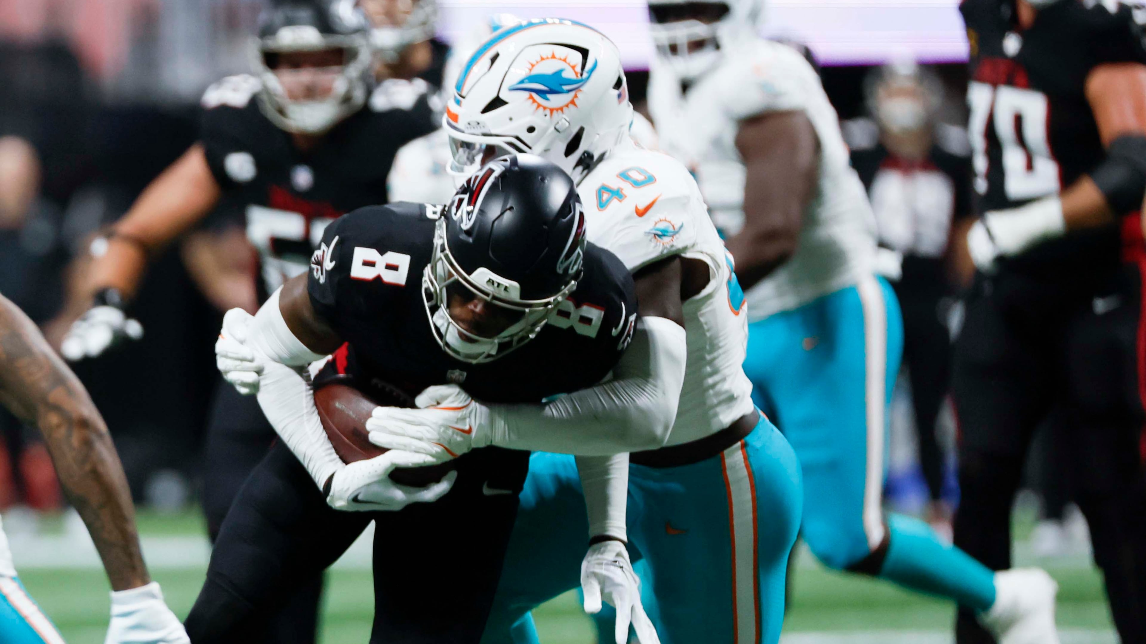 Atlanta Falcons tight end Kyle Pitts (8) gets tacke by Miami Dolphins linebacker Willie Gay Jr. (40) during the second half of an NFL football game at Mercedes-Benz Stadium in Atlanta on Sunday, October 26, 2025. (Miguel Martinez/AJC)