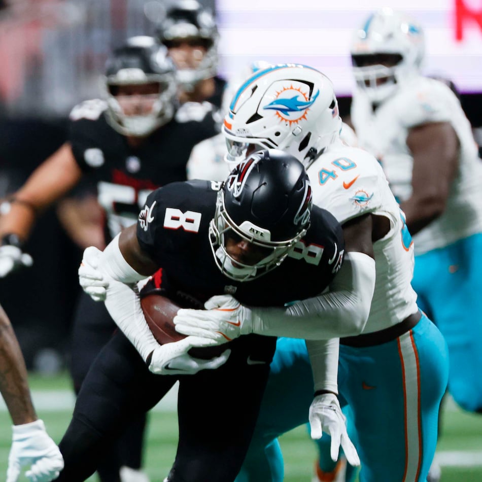 Atlanta Falcons tight end Kyle Pitts (8) gets tacke by Miami Dolphins linebacker Willie Gay Jr. (40) during the second half of an NFL football game at Mercedes-Benz Stadium in Atlanta on Sunday, October 26, 2025. (Miguel Martinez/AJC)