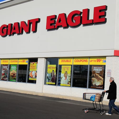 FILE - A man walks out of the Giant Eagle grocery store Thursday, Nov. 17, 2011, in Mayfield Heights, Ohio. (AP Photo/Tony Dejak, File)