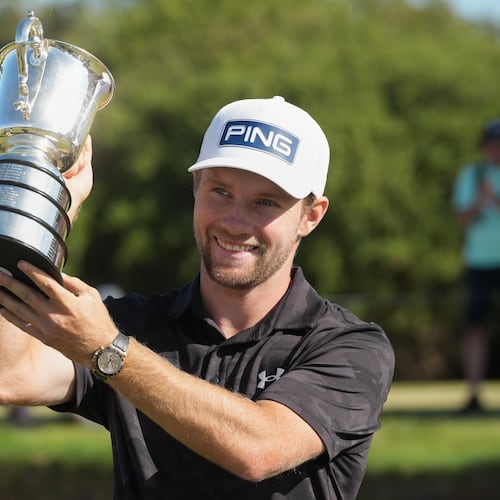 Denmark's Rasmus Neergaard-Petersen holds the Stonehaven Cup after winning the Australian Open golf tournament in Melbourne, Australia, Sunday, Dec. 7, 2025. (AP Photo/Asanka Brendon Ratnayake)