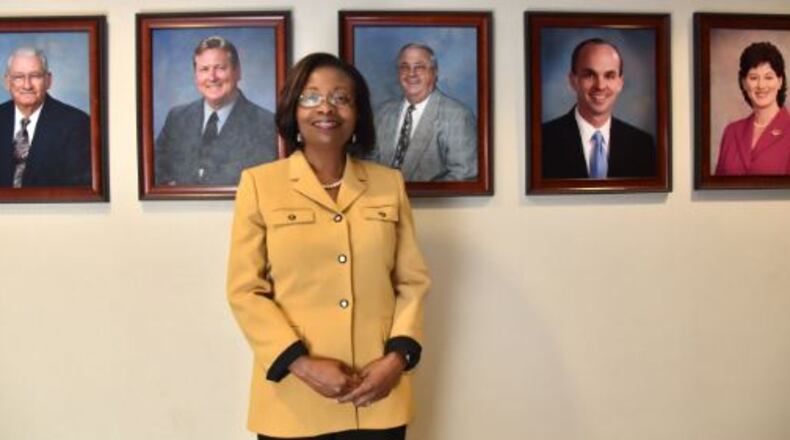 Portrait of newly elected Henry County Commission Chair June Wood in front of photographs of previous chairs of the Board of Commissioners. HYOSUB SHIN / HSHIN@AJC.COM