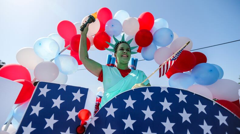 Cathy Smith was the state of liberty on the Avonlea Apartments float. Hundreds of spectators lined the streets of Marietta Tuesday, July 4, 2017 for the Marietta Freedom Parade.