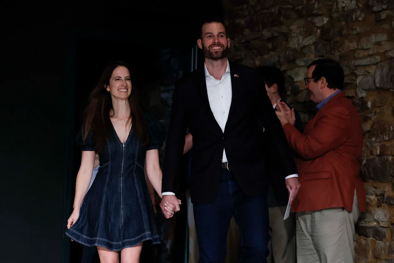 Clay Fuller and his wife, Kate Fuller, walk on stage for his victory speech after winning the 14th District runoff election on Tuesday, April 7, 2026. (Miguel Martinez/AJC)