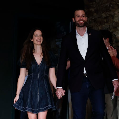Clay Fuller and his wife, Kate Fuller, walk on stage for his victory speech after winning the 14th District runoff election on Tuesday, April 7, 2026. (Miguel Martinez/AJC)