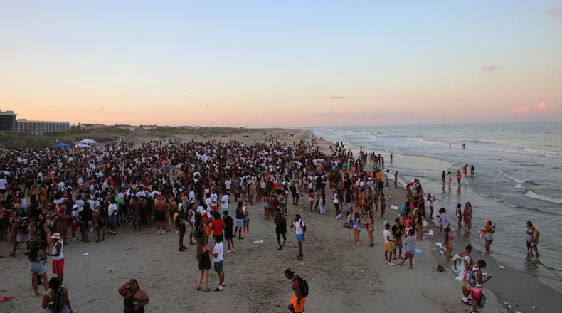 A large crowd of people enjoy the Tybee beach at sunset during Orange Crush on Saturday. (Photo Courtesy of RJ Smith/Savannah Morning News)