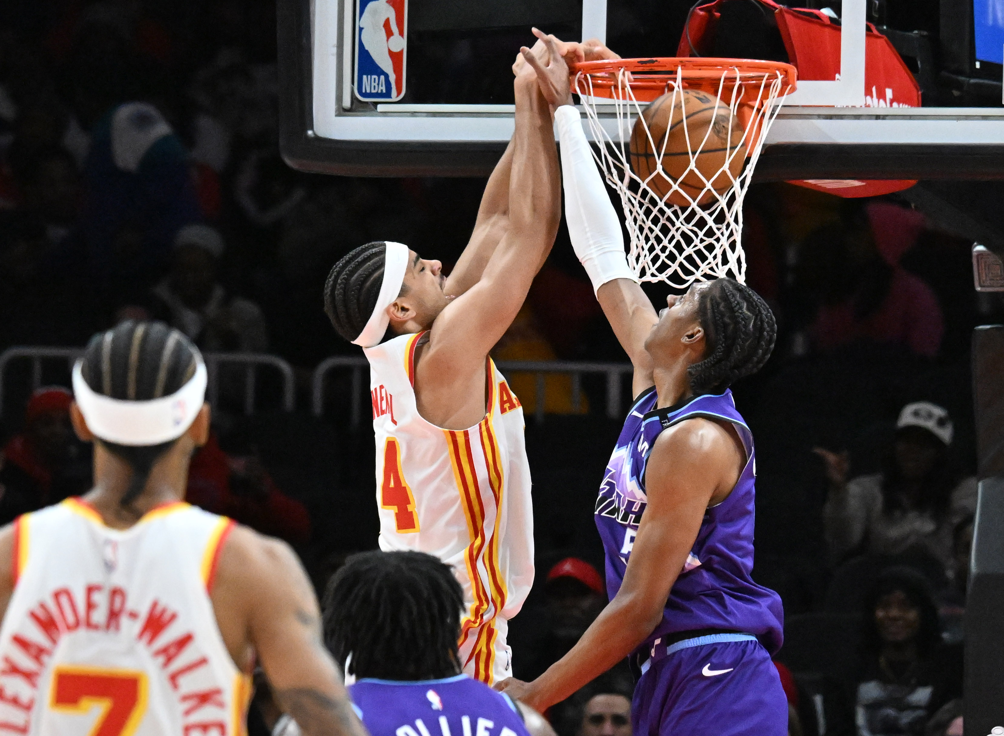 Atlanta Hawks forward Asa Newell (14) dunks against Utah Jazz forward Cody Williams (5) during the first half in an NBA basketball game at State Farm Arena, Thursday, Feb. 5, 2026, in Atlanta. (Hyosub Shin/AJC)