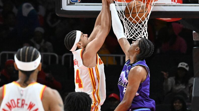 Atlanta Hawks forward Asa Newell (14) dunks against Utah Jazz forward Cody Williams (5) during the first half in an NBA basketball game at State Farm Arena, Thursday, Feb. 5, 2026, in Atlanta. (Hyosub Shin/AJC)