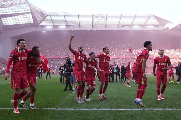 Liverpool players celebrate after winning the English Premier League soccer match between Liverpool and Tottenham Hotspur and clinching the Premier League title at Anfield in Liverpool, England, Sunday, April 27, 2025. (AP Photo/Jon Super)
