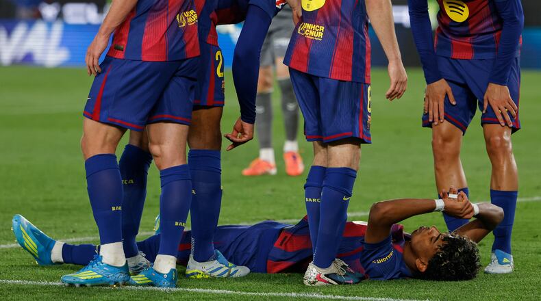 Barcelona's Lamine Yamal lies on the pitch in pain during the Spanish La Liga soccer match between Barcelona and Celta Vigo in Barcelona, Spain, Wednesday, April 22, 2026. (AP Photo/Joan Monfort)