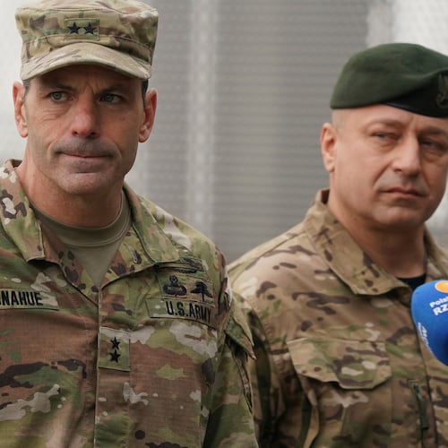 FILE - U.S. Army General Christopher Donahue, left, commanding general of the 82nd Airborne Division, and Polish General Wojciech Marchwica speak to journalists after unloading vehicles from a transport plane arriving from Fort Bragg at the Rzeszow-Jasionka airport in southeastern Poland, on Feb. 6, 2022. (AP Photo, File)