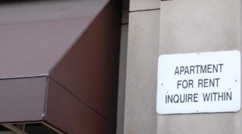 An image of a building with an apartment for rent sign.