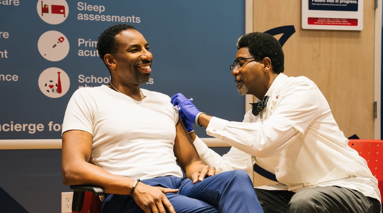 Atlanta City Mayor Andre Dickens gets his vaccination for the flu at CVS Pharmacy, in the spirit of encouraging others to do the same. At the event, he spoke briefly about the city's plans for the site of the former Wellstar Atlanta Medical Center, which has been empty for a year. Friday, Oct. 6, 2023. (Olivia Bowdoin for the AJC).