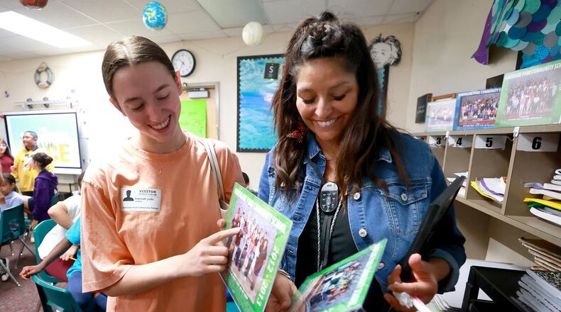 Lake Nona High School senior Hannah Juda points herself out in a class photo after surprising her fifth grade teacher, Dagmar Kilp, at Northlake Park Community School, with a thank you letter she wrote, May 4, 2022. (Joe Burbank/Orlando Sentinel/TNS)