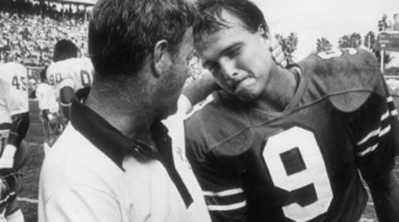 Miami quarterback Mark Richt is consoled by Florida State head coach Bobby Bowden after the Seminoles defeated the Hurricanes 24-7 in 1982.