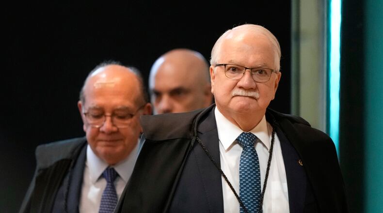 Supreme Court President Justice Edson Fachin, front, arrives to preside over a plenary session of the court in Brasilia, Brazil, Wednesday, Sept. 2, 2026. (AP Photo/Eraldo Peres)