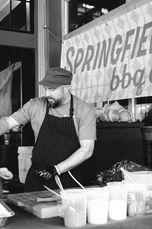 Chef preparing food at a Springfield BBQ pop-up.