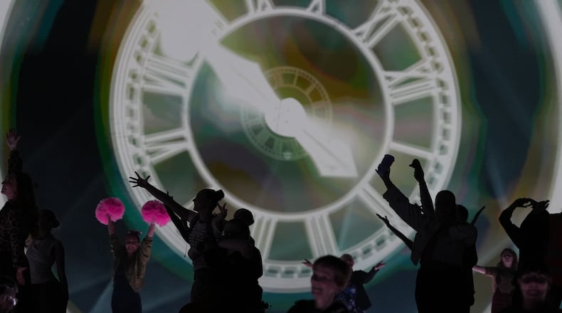 FILE - Performers celebrate the Glasgow Central railway station clock during the Commonwealth Games opening ceremony in Glasgow, Scotland, July 23, 2026. (AP Photo/Kin Cheung, File)
