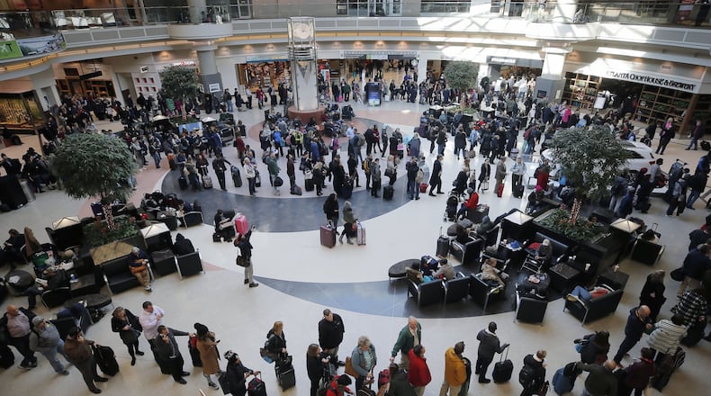 Security lines wrapped through the atrium and around the baggage areas and wait times were more than two hours long at Hartsfield-Jackson International Airport on Wednesday afternoon in the wake of a snowstorm due to a shortage of TSA screeners.BOB ANDRES /BANDRES@AJC.COM