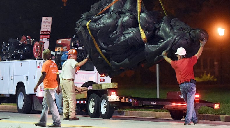 Workers remove a monument dedicated to the Confederate Women of Maryland early Aug. 16, 2017, after it was taken down in Baltimore. Local news outlets reported that workers hauled several monuments away, days after a white nationalist rally in Virginia turned deadly.