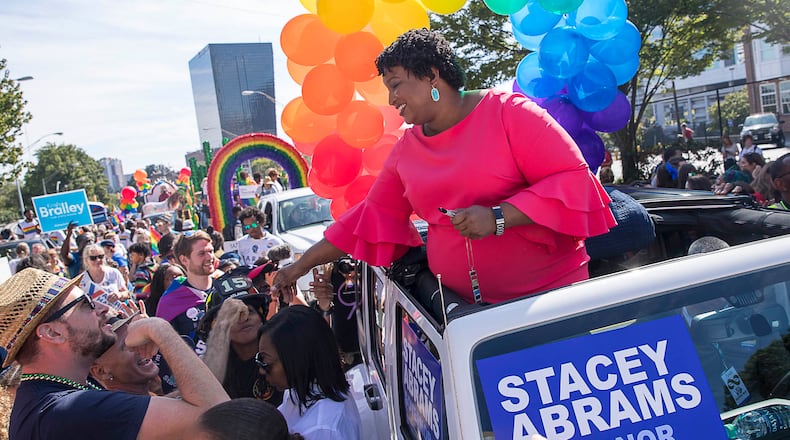 Gubernatorial candidate Stacey Abrams greets supporters at the Atlanta Pride Parade. Abrams made history by being the first ever Georgia gubernatorial candidate to ride along in the parade.