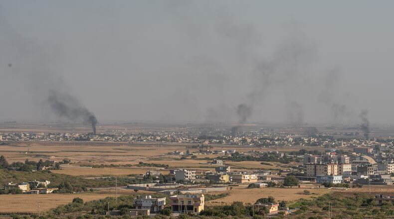 CEYLANPINAR, TURKEY - OCTOBER 10: Smoke rises over the Syrian town of Ras al-Ain, as seen from the Turkish border town on October 09, 2019 in Ceylanpinar, Turkey. The military action is part of a campaign to extend Turkish control of more of northern Syria, a large swath of which is currently held by Syrian Kurds, whom Turkey regards as a threat. U.S. President Donald Trump granted tacit American approval to this campaign, withdrawing his country's troops from several Syrian outposts near the Turkish border. (Photo by Burak Kara/Getty Images)