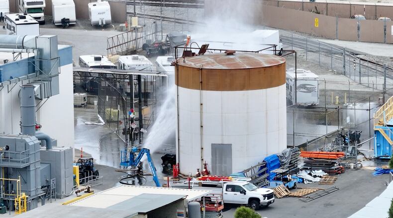 Water is sprayed on a tank that overheated at an aerospace plant in Garden Grove, Calif., Friday, May 22, 2026. (Jeff Gritchen/The Orange County Register via AP)